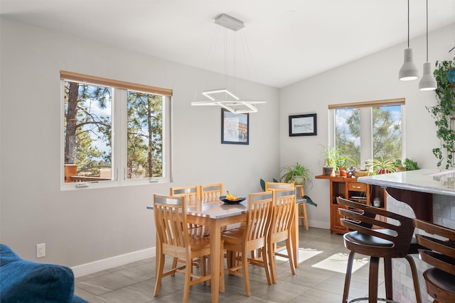 dining area with lofted ceiling and baseboards