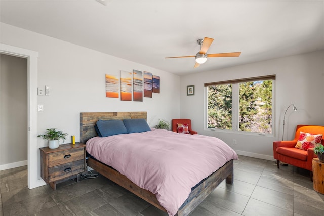 bedroom with baseboards and a ceiling fan