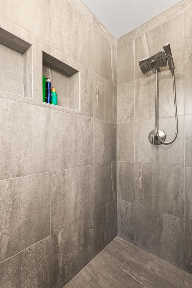 bathroom with a tile shower