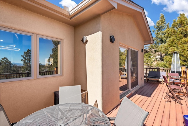 wooden deck featuring outdoor dining area