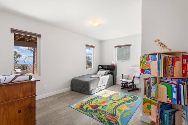 bedroom featuring multiple windows and baseboards