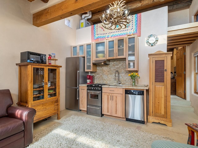 kitchen featuring beam ceiling, stainless steel appliances, tasteful backsplash, light countertops, and glass insert cabinets