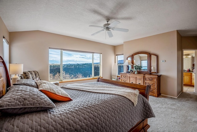 bedroom with lofted ceiling, a ceiling fan, light carpet, a textured ceiling, and baseboards