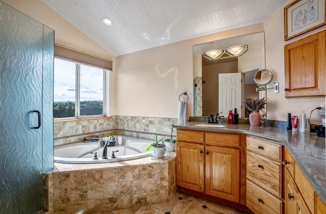 full bath with lofted ceiling, a garden tub, vanity, and a textured ceiling