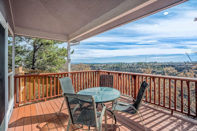 wooden terrace with outdoor dining area