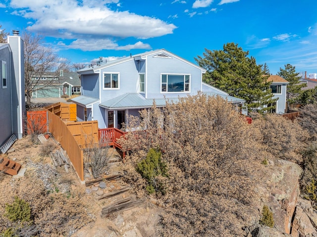 view of front of home featuring fence