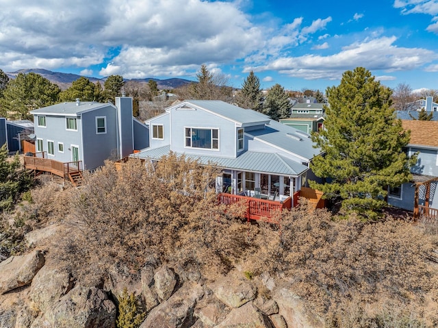 exterior space with metal roof and a deck with mountain view