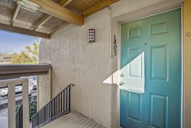 doorway to property featuring stucco siding