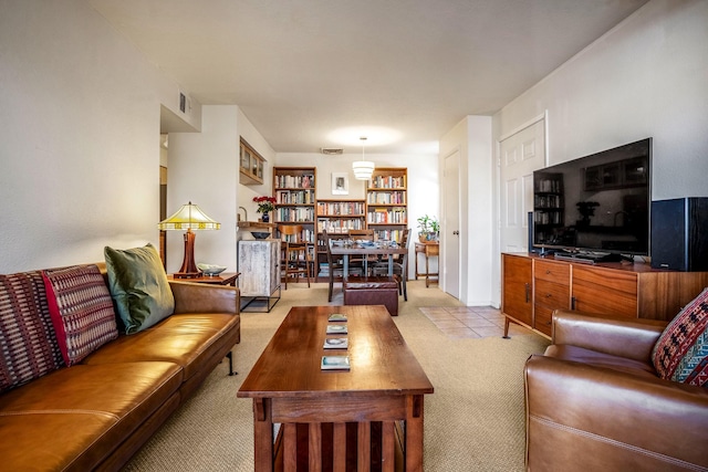 living area with built in features and light colored carpet