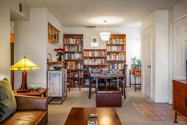 living area featuring carpet flooring and visible vents