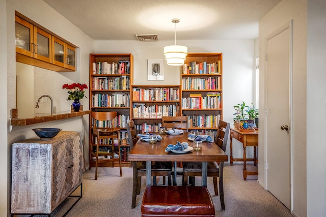 sitting room featuring baseboards, visible vents, and carpet flooring