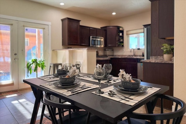 dining room featuring french doors, light tile patterned flooring, and recessed lighting