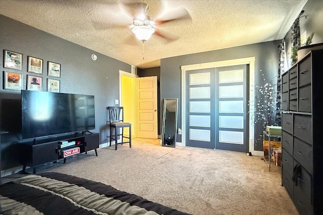 carpeted bedroom with a closet, baseboards, a textured ceiling, and a textured wall