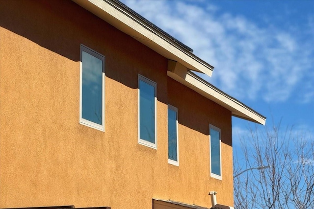 view of side of home featuring stucco siding