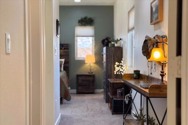 hallway featuring light carpet