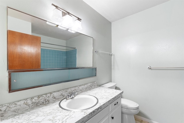 bathroom with walk in shower, vanity, toilet, and baseboards