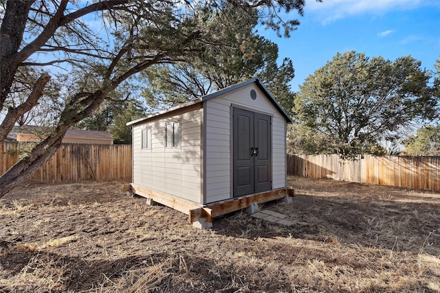 view of shed with a fenced backyard