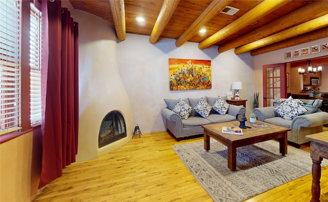 living room featuring wooden ceiling, light wood-style floors, and a notable chandelier