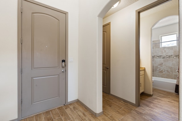 interior space with wood tiled floor and baseboards