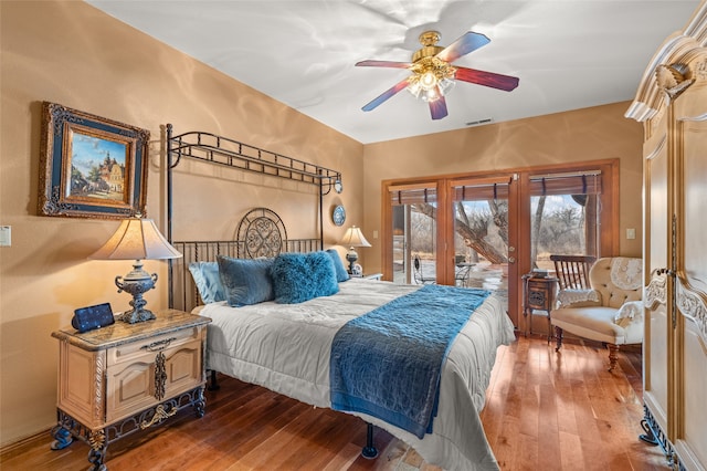 bedroom featuring access to exterior, a ceiling fan, visible vents, and hardwood / wood-style flooring