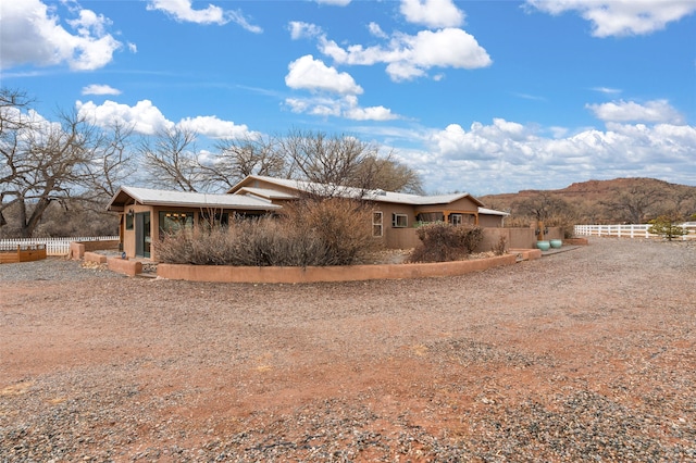 exterior space with fence and a mountain view