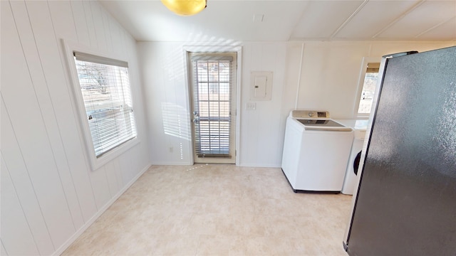 washroom with washer / dryer, laundry area, electric panel, light floors, and a decorative wall