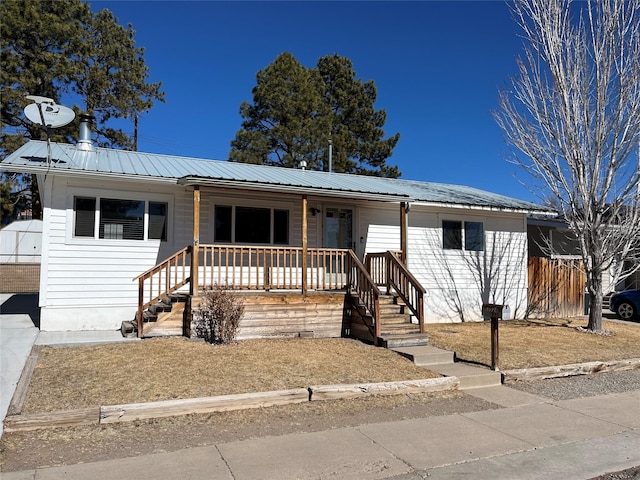 view of front of home featuring metal roof and a porch