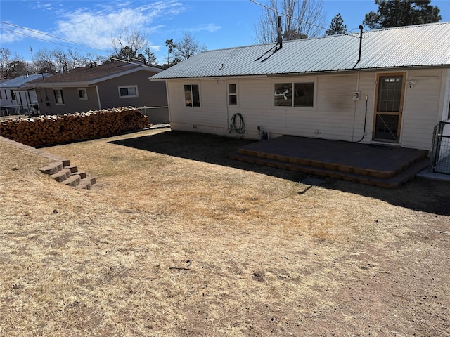 rear view of property featuring metal roof and crawl space