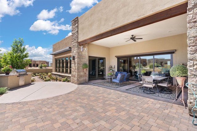 view of patio / terrace with ceiling fan, grilling area, exterior kitchen, and outdoor dining space