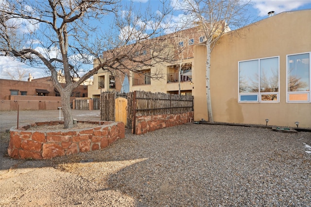 exterior space with fence and stucco siding