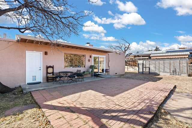 1115 N Luna Cir, Santa Fe, NM 87501 - rear view of property featuring a gate, stucco siding, and a patio area