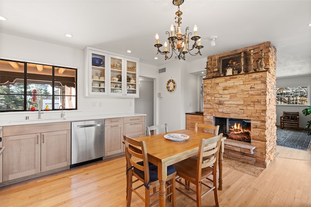 1115 N Luna Cir, Santa Fe, NM 87501 - dining space with healthy amount of natural light, light wood finished floors, a stone fireplace, and recessed lighting