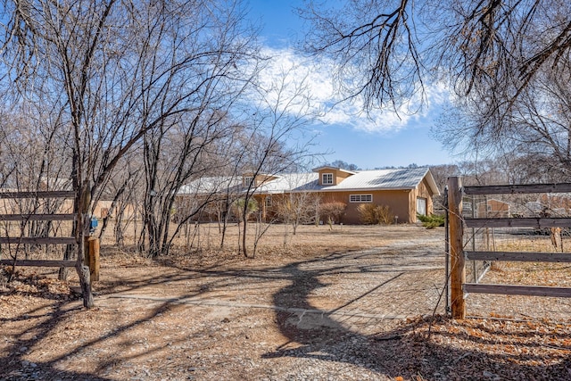 view of yard featuring driveway and fence