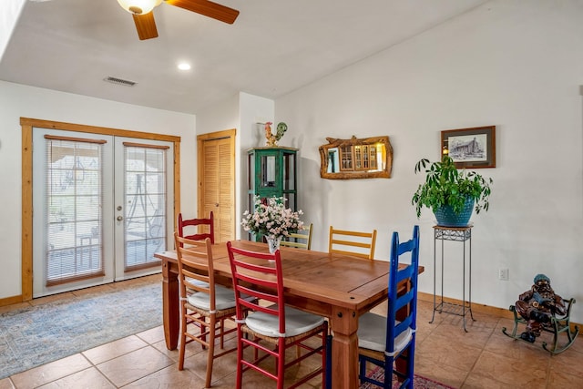 dining room featuring ceiling fan, visible vents, baseboards, vaulted ceiling, and french doors