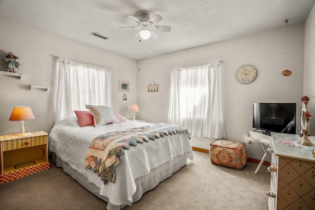 bedroom with multiple windows, visible vents, a ceiling fan, and light colored carpet