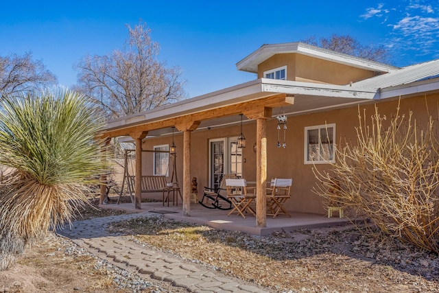 doorway to property with french doors and stucco siding