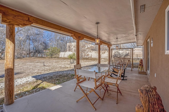 view of patio / terrace with outdoor dining area and fence