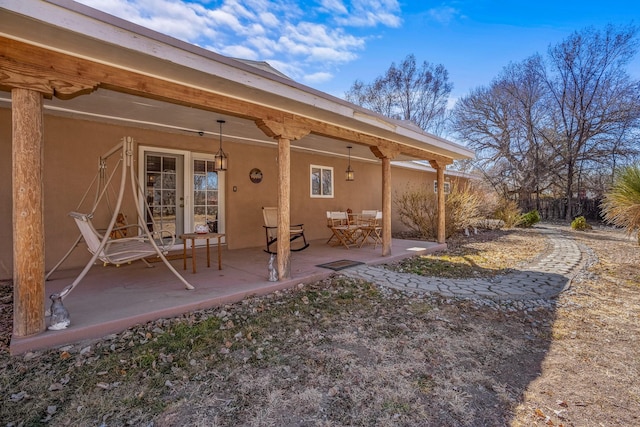 back of property featuring a patio area, fence, and stucco siding