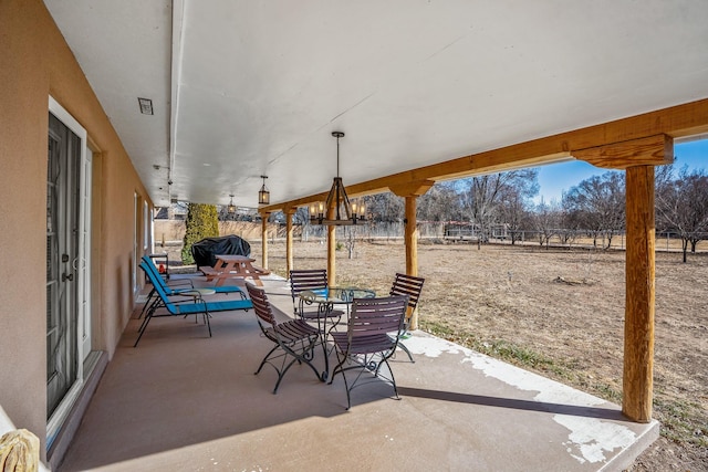 view of patio / terrace with visible vents, fence, and outdoor dining area