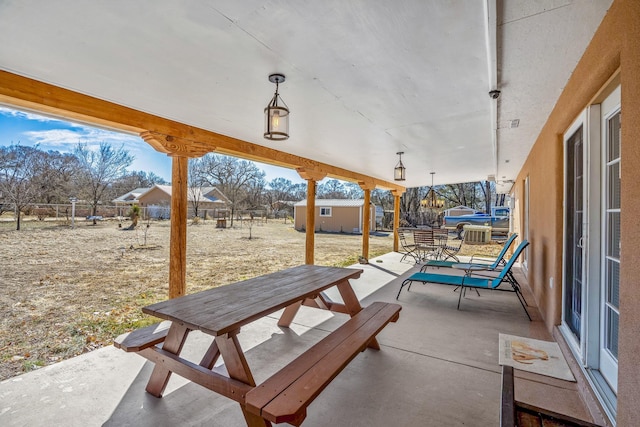 view of patio featuring outdoor dining area and an outdoor structure