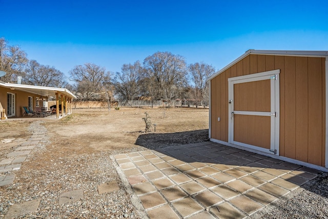 view of yard with a patio area, a storage shed, and an outdoor structure