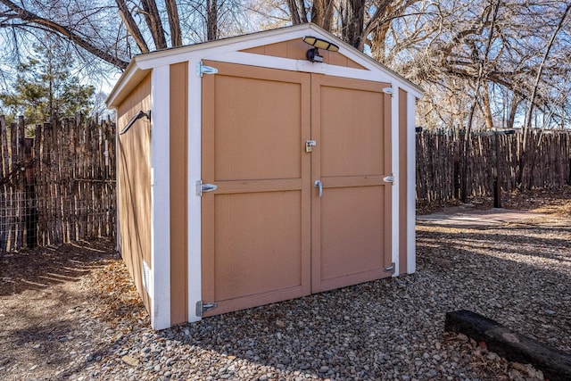 view of shed with fence