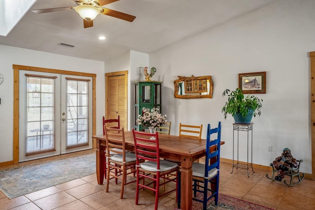 tiled dining space with ceiling fan, french doors, visible vents, and baseboards