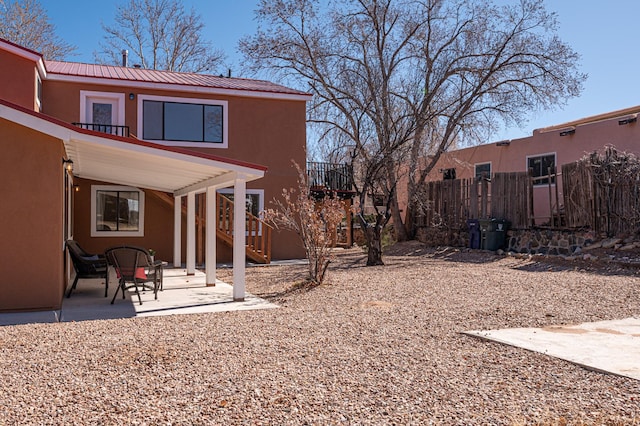 view of yard featuring a patio area, fence, and stairway