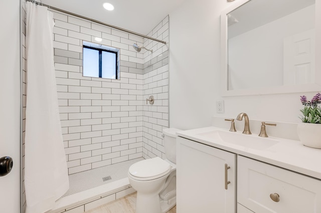 full bath with a stall shower, vanity, and toilet