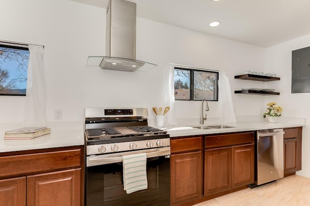 kitchen featuring island range hood, appliances with stainless steel finishes, brown cabinetry, and a sink