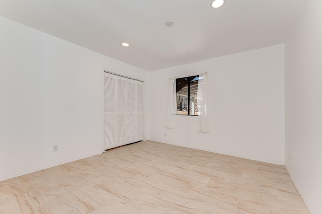 unfurnished room featuring recessed lighting