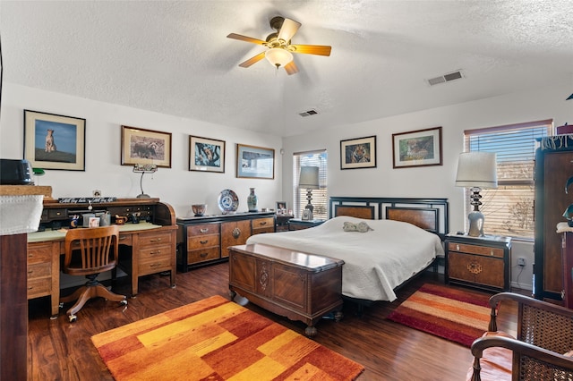 bedroom featuring a textured ceiling, wood finished floors, visible vents, and a ceiling fan