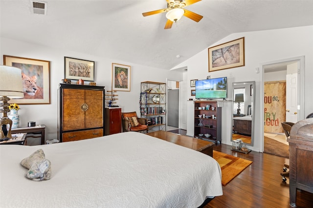 bedroom with lofted ceiling, visible vents, and wood finished floors