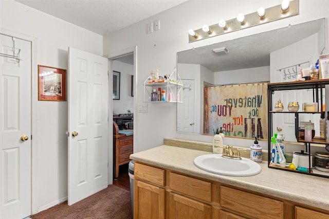 bathroom with curtained shower and vanity